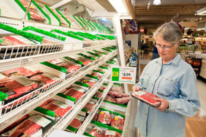 woman shopping in the meat aisle