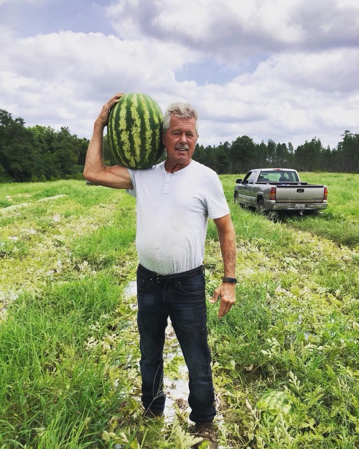 Outstanding in his field: Jim Lambeth shows off a giant watermelon he grew.