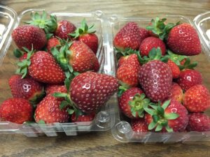 Ripe strawberries in a plastic clamshell.